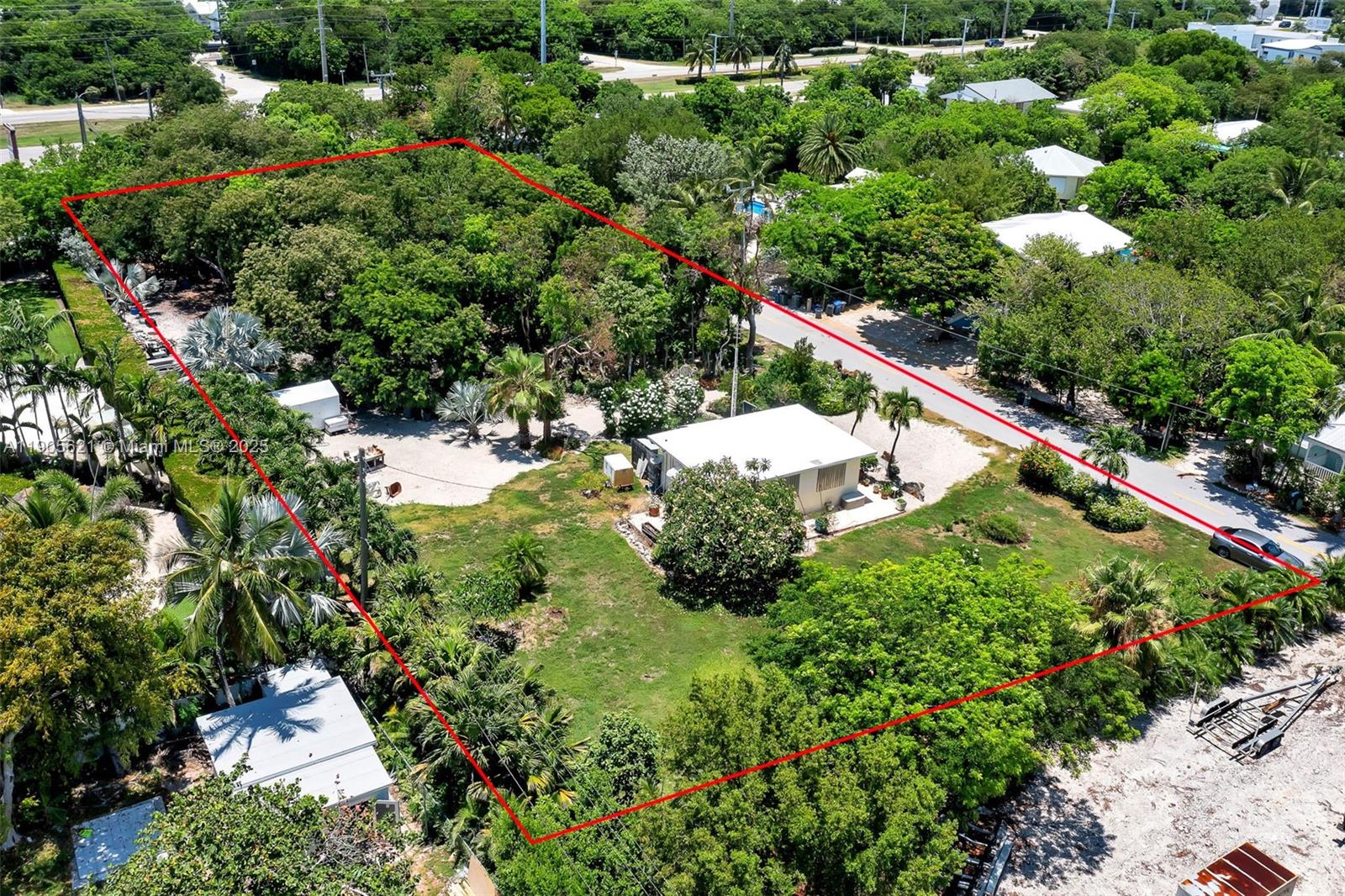306 Lime Street Key Largo, FL 33037 - Photo 10 of 37 a view of a house with a lush green forest