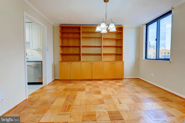 a view of a room with a cabinet and a chandelier