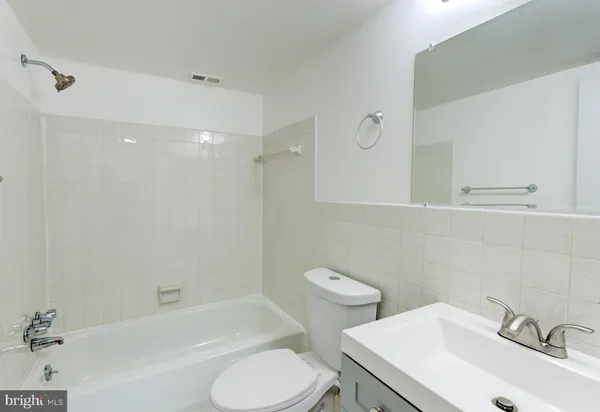 a bathroom with a sink toilet and bathtub