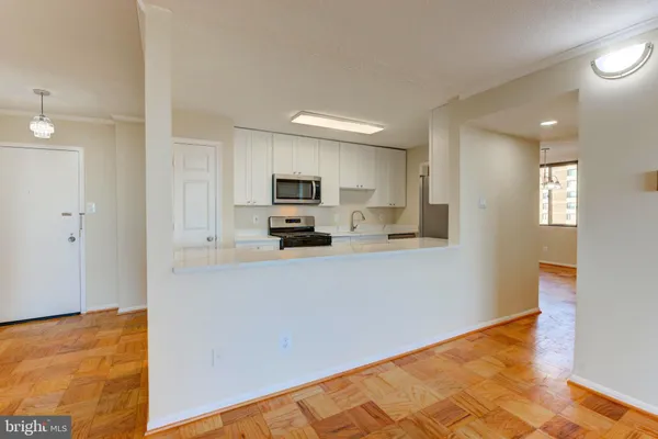 a kitchen with stainless steel appliances a refrigerator sink and microwave