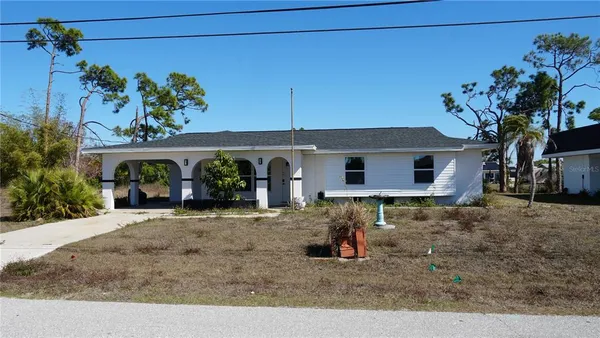front view of a house with potted plants