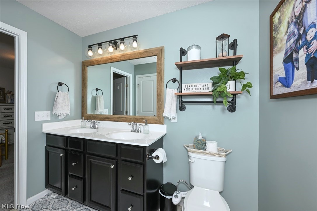 3021 Stonehurst Road Uniontown, OH 44685 - Photo 26 of 48 *ENSUITE FULL MASTER BATHROOM W/TUB & SHOWER, HIS AND HER VANITY & SINKS, 5 SCONCE UPDATED LIGHTING AND CUSTOM WOOD MIRROR SURROUND ~