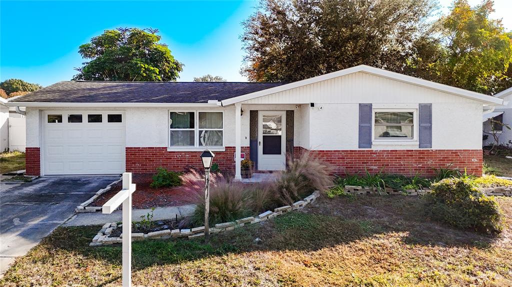 9420 Cochise Lane Port Richey, FL 34668 - Photo 1 of 47 a view of a house with a yard