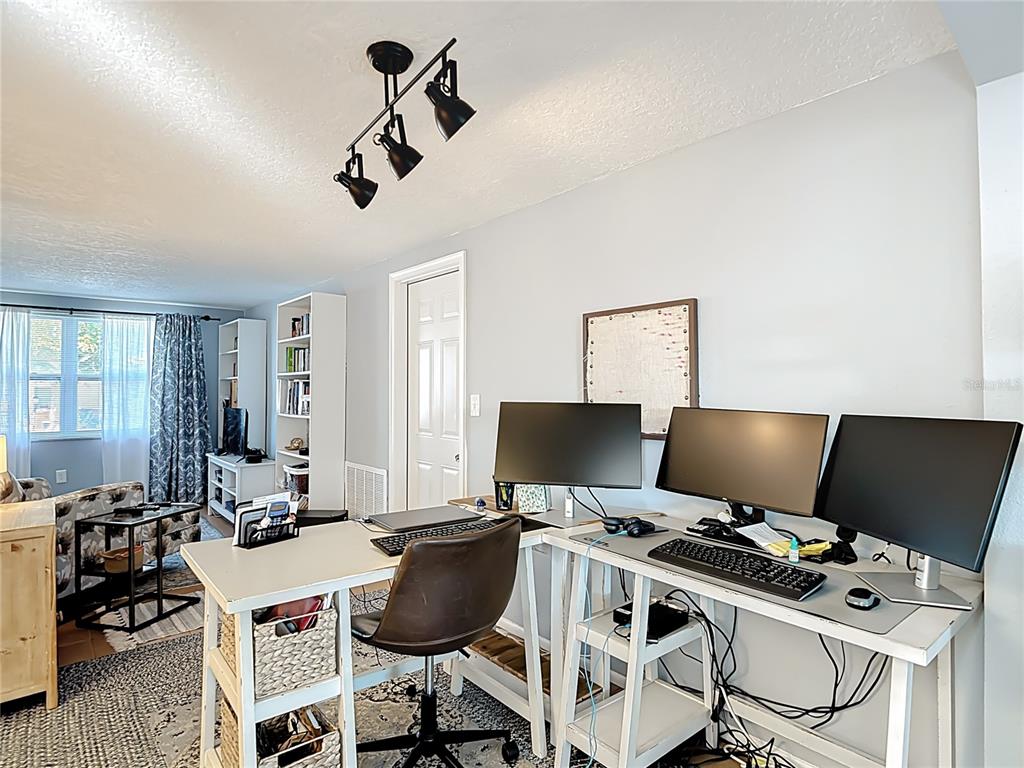 9420 Cochise Lane Port Richey, FL 34668 - Photo 13 of 47 a view of a workspace with furniture and a window