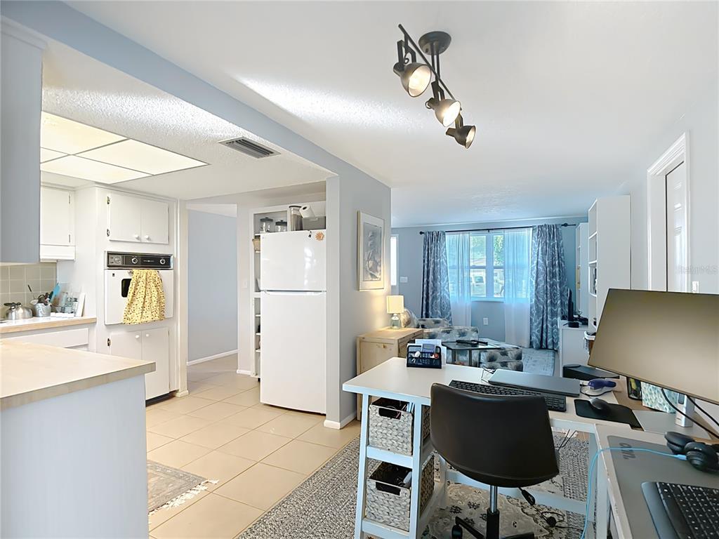 9420 Cochise Lane Port Richey, FL 34668 - Photo 14 of 47 a living room with stainless steel appliances kitchen island granite countertop furniture a sink a rug and a window