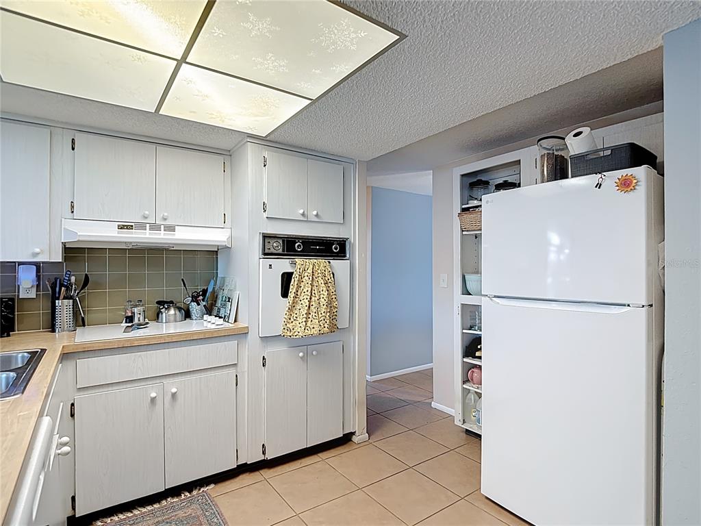 9420 Cochise Lane Port Richey, FL 34668 - Photo 15 of 47 a kitchen with stainless steel appliances a refrigerator sink and cabinets