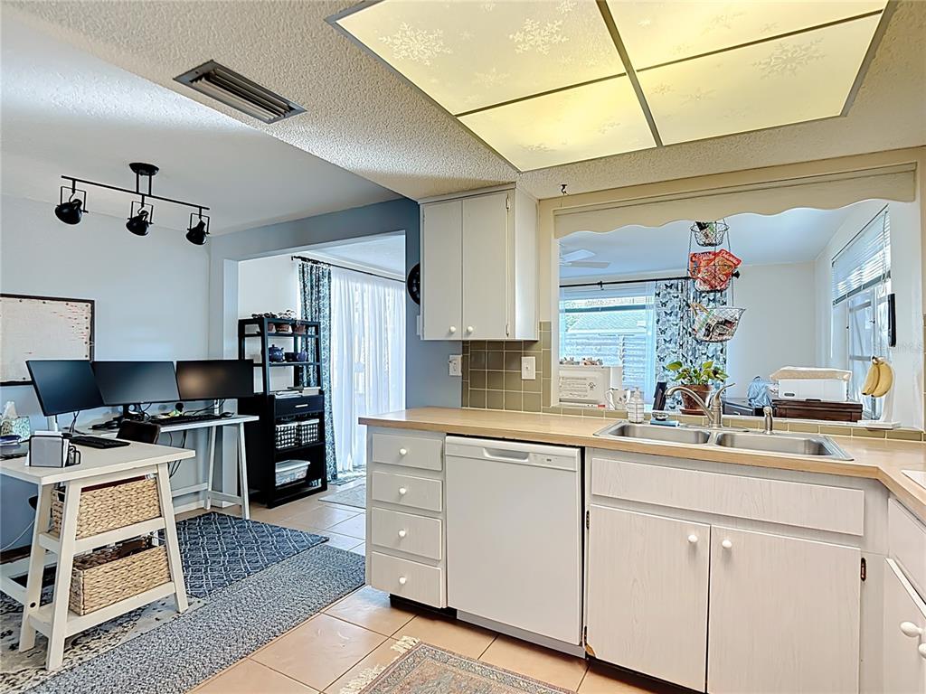 9420 Cochise Lane Port Richey, FL 34668 - Photo 18 of 47 a kitchen with white cabinets and appliances