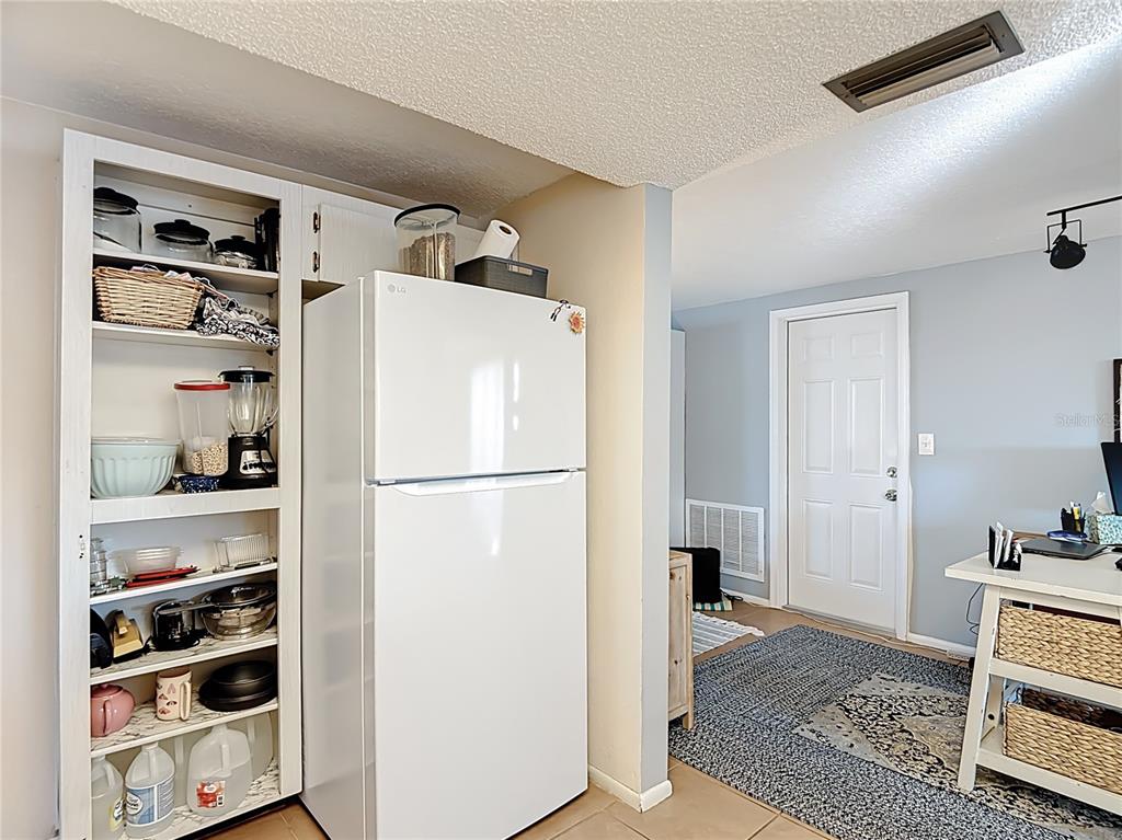 9420 Cochise Lane Port Richey, FL 34668 - Photo 19 of 47 a white refrigerator freezer and a wooden floor