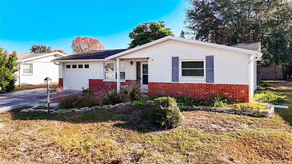 9420 Cochise Lane Port Richey, FL 34668 - Photo 2 of 47 a view of a house with a yard