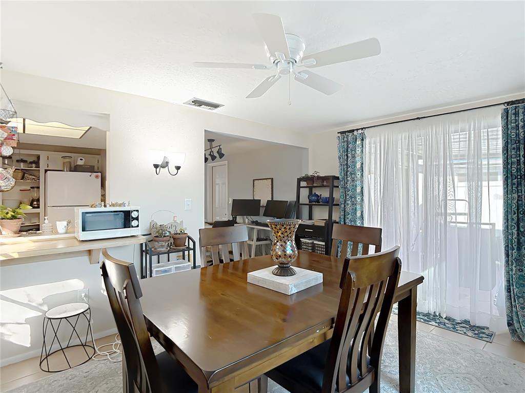9420 Cochise Lane Port Richey, FL 34668 - Photo 22 of 47 a view of a dining room with furniture and wooden floor