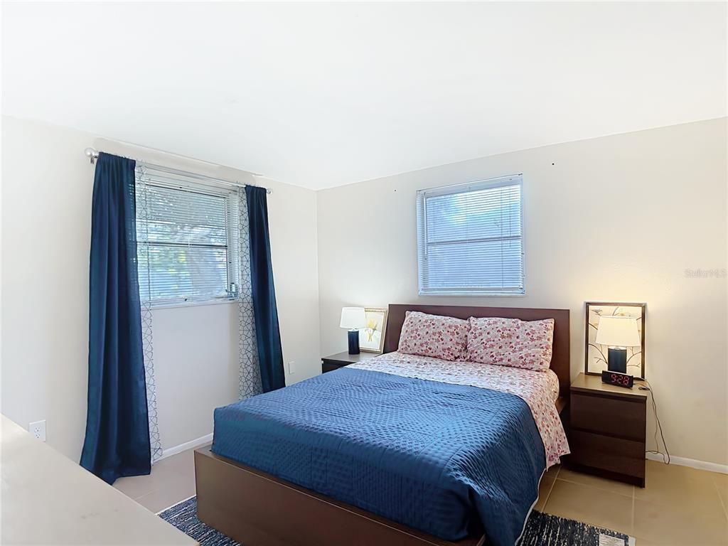 9420 Cochise Lane Port Richey, FL 34668 - Photo 24 of 47 a bedroom with a bed and wooden floor