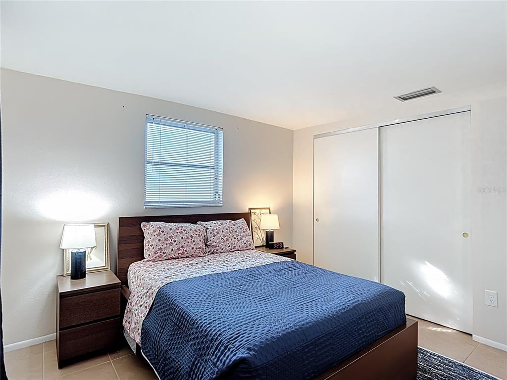 9420 Cochise Lane Port Richey, FL 34668 - Photo 25 of 47 a bedroom with a bed and a night stand