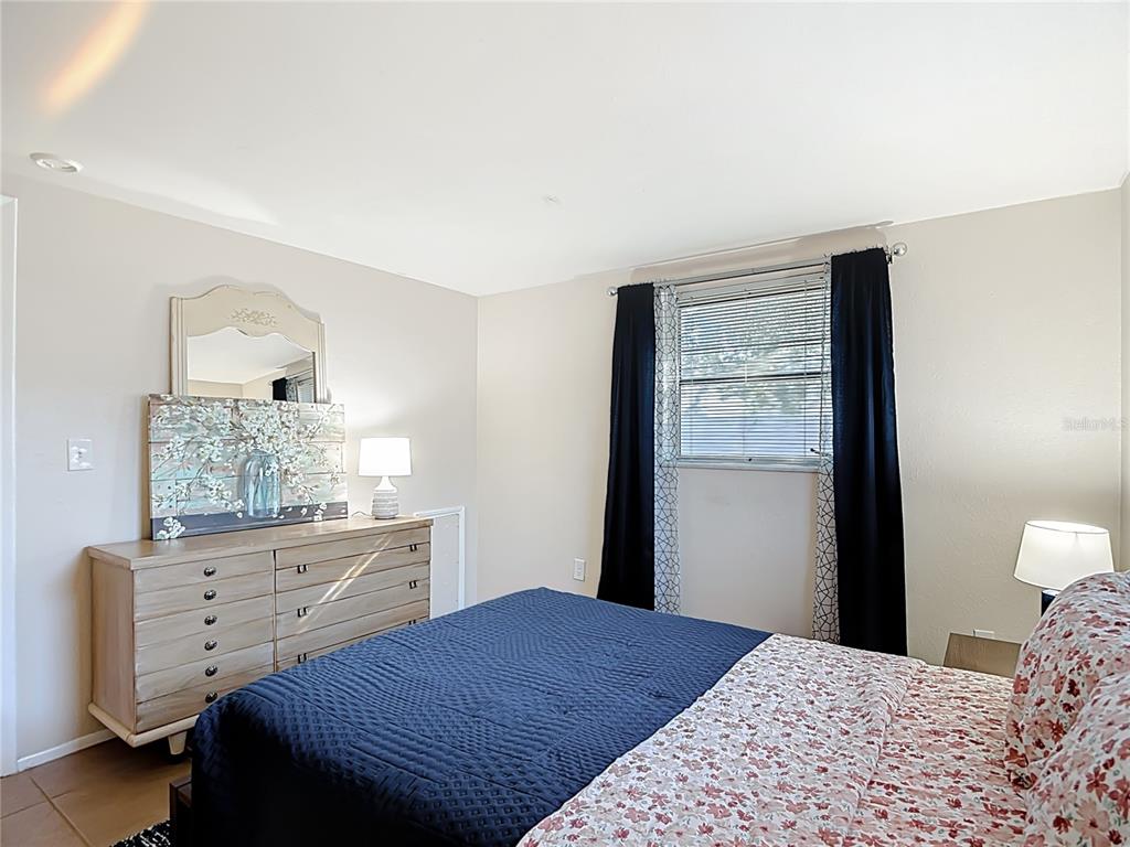 9420 Cochise Lane Port Richey, FL 34668 - Photo 26 of 47 a bedroom with a bed and a dresser