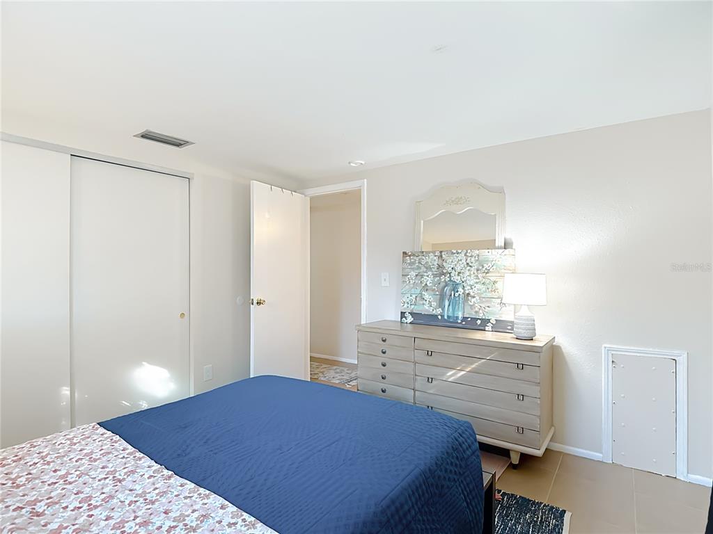 9420 Cochise Lane Port Richey, FL 34668 - Photo 27 of 47 a bedroom with a bed and a window