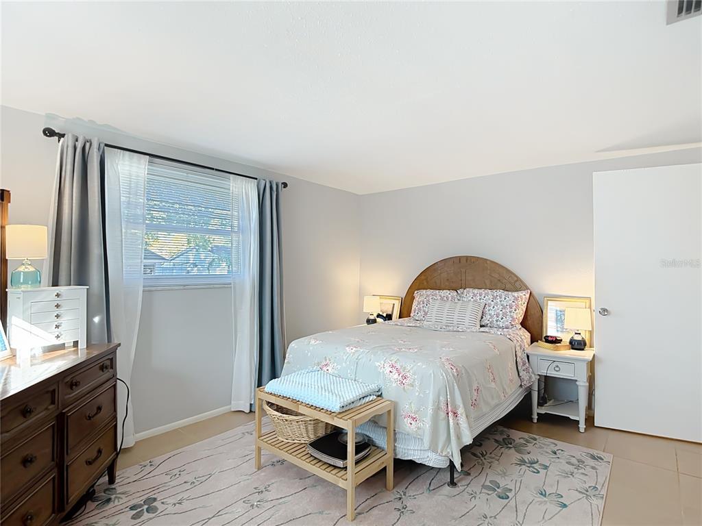 9420 Cochise Lane Port Richey, FL 34668 - Photo 28 of 47 a bedroom with a bed and a dresser with wooden floor