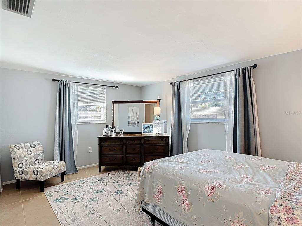 9420 Cochise Lane Port Richey, FL 34668 - Photo 29 of 47 a bedroom with a bed and wooden floor