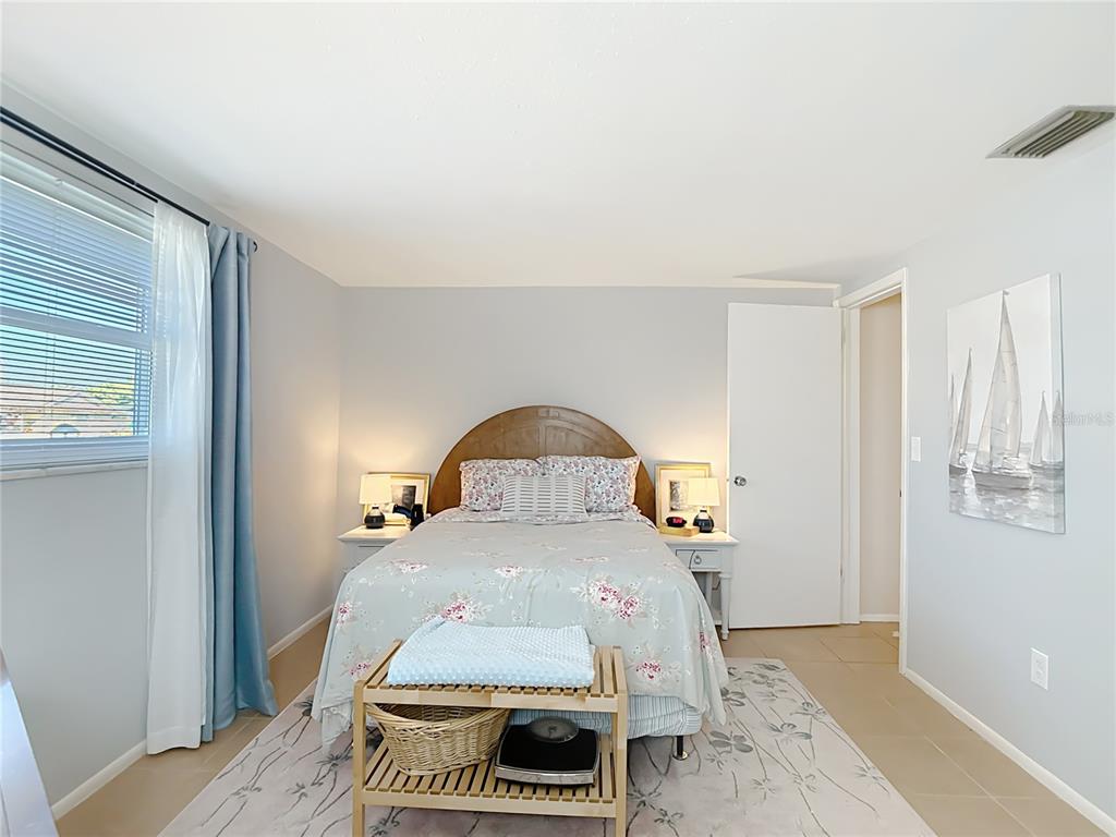 9420 Cochise Lane Port Richey, FL 34668 - Photo 30 of 47 a bedroom with a bed and a wooden floor