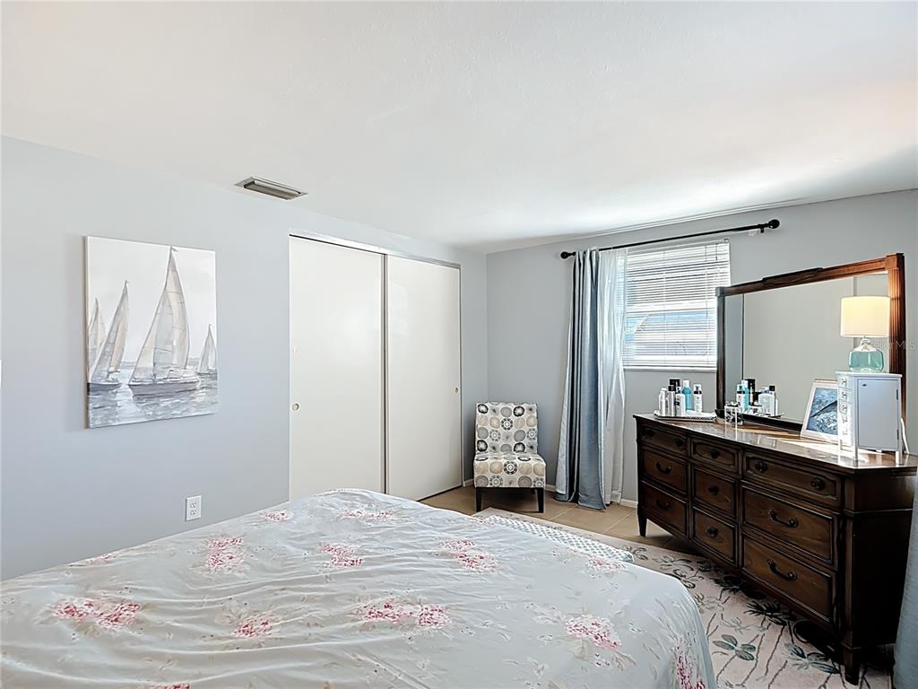 9420 Cochise Lane Port Richey, FL 34668 - Photo 31 of 47 a bedroom with a bed and a dresser