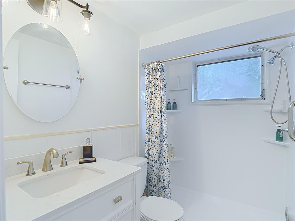 9420 Cochise Lane Port Richey, FL 34668 - Photo 32 of 47 a bathroom with a sink toilet and shower