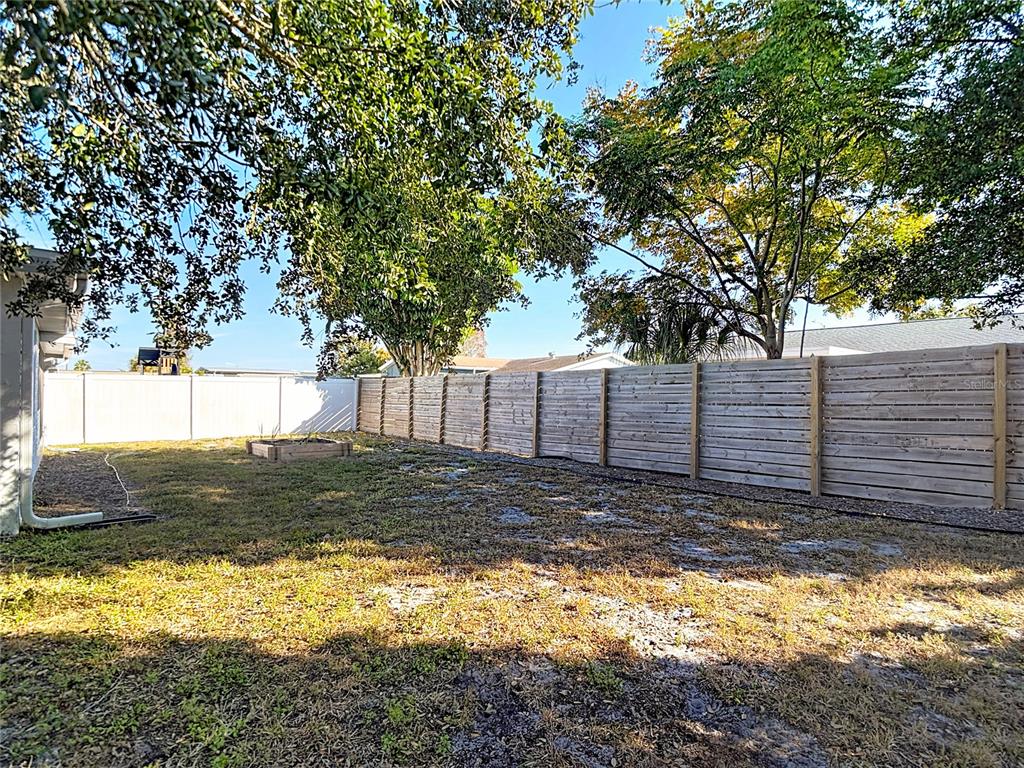9420 Cochise Lane Port Richey, FL 34668 - Photo 38 of 47 a view of a backyard with large trees