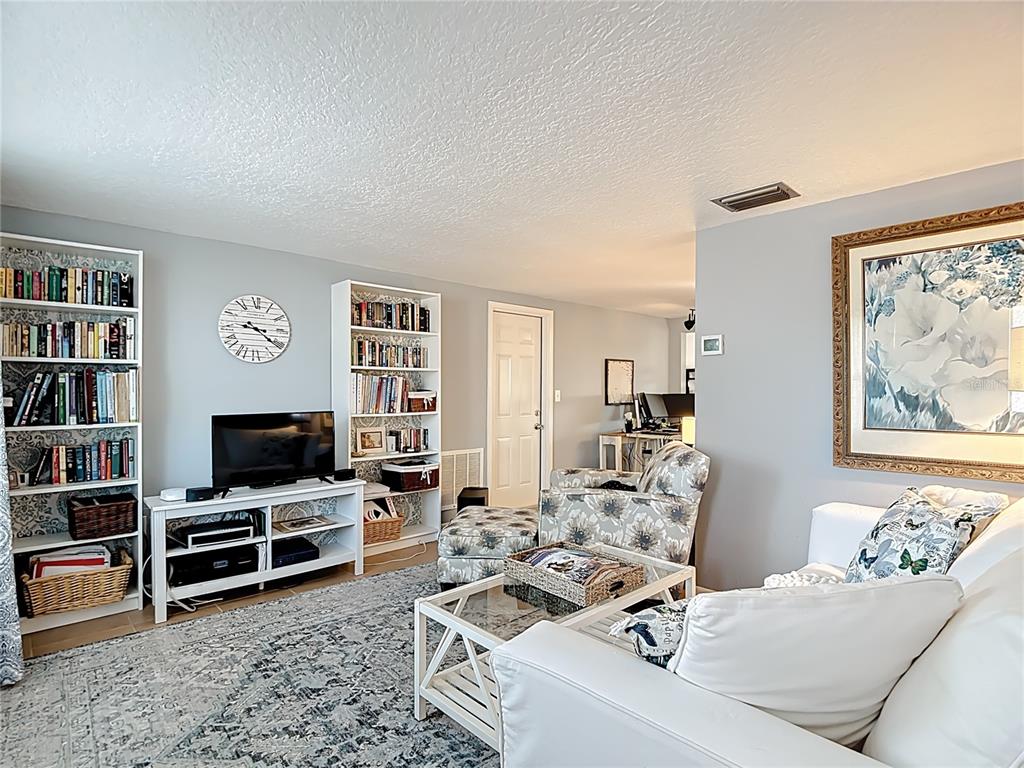 9420 Cochise Lane Port Richey, FL 34668 - Photo 5 of 47 a view of a livingroom with furniture and a flat screen tv