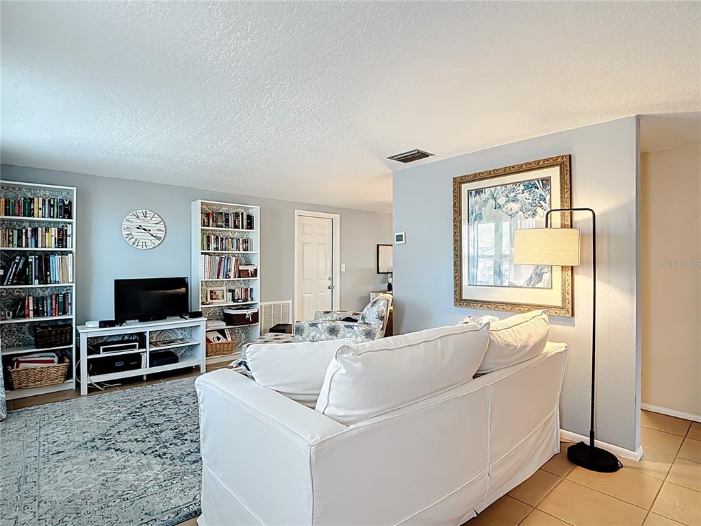 9420 Cochise Lane Port Richey, FL 34668 - Photo 6 of 47 a living room with furniture a flat screen tv and a window