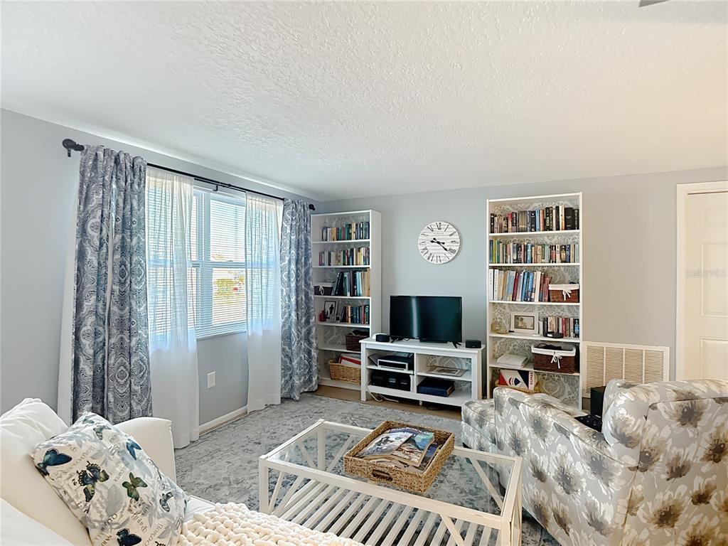 9420 Cochise Lane Port Richey, FL 34668 - Photo 8 of 47 a bedroom with furniture and a window