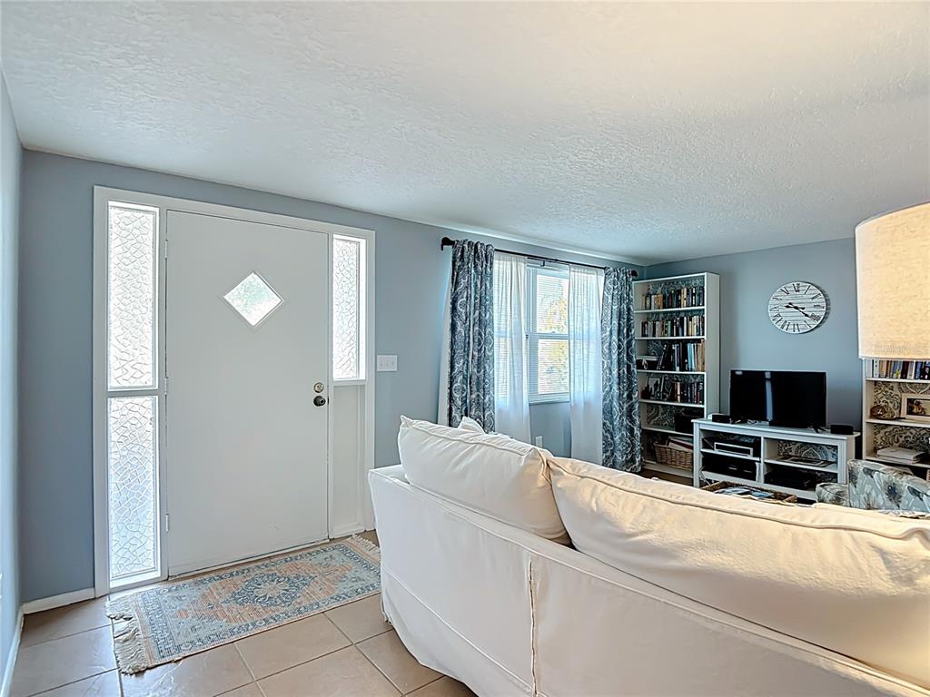 9420 Cochise Lane Port Richey, FL 34668 - Photo 9 of 47 a living room with furniture and a flat screen tv