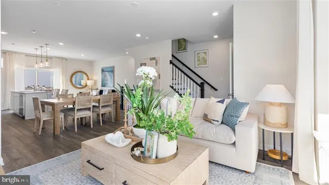 a living room with furniture potted plant and a table