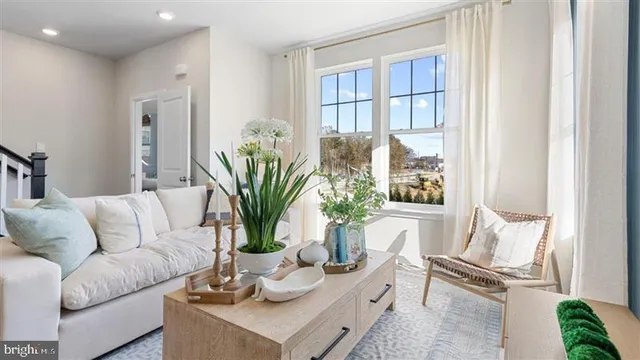 a living room with furniture and a potted plant