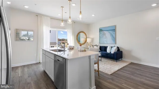 a view of living room with granite countertop furniture and wooden floor