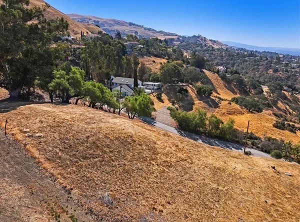 a view of a road with mountains in the background
