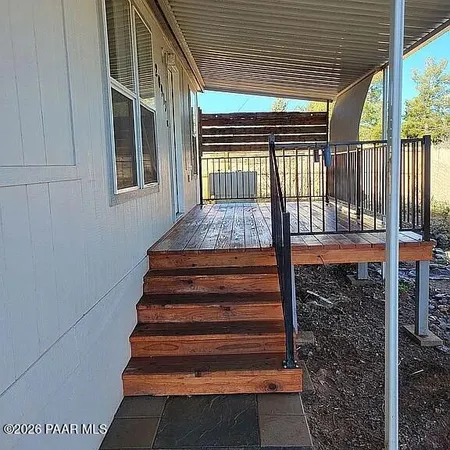 a view of a roof deck with table and chairs under an umbrella