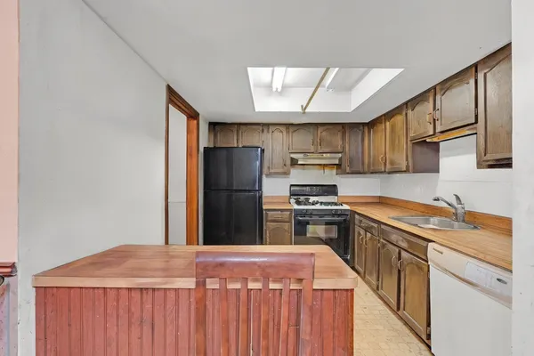 a kitchen with stainless steel appliances granite countertop a refrigerator a stove a sink dishwasher and wooden cabinets