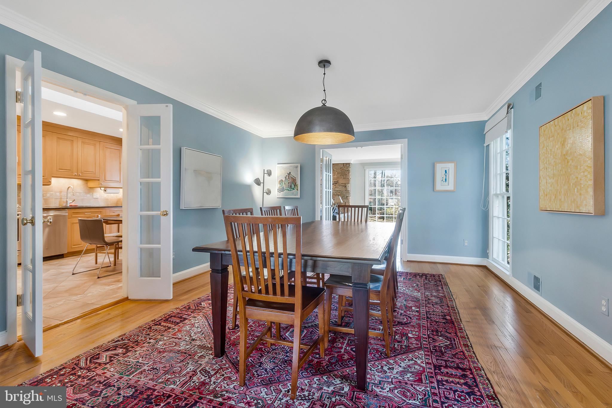 2812 Greenvale Street Chevy Chase, MD 20815 - Photo 11 of 27 a dining room with furniture wooden floor a rug and a chandelier
