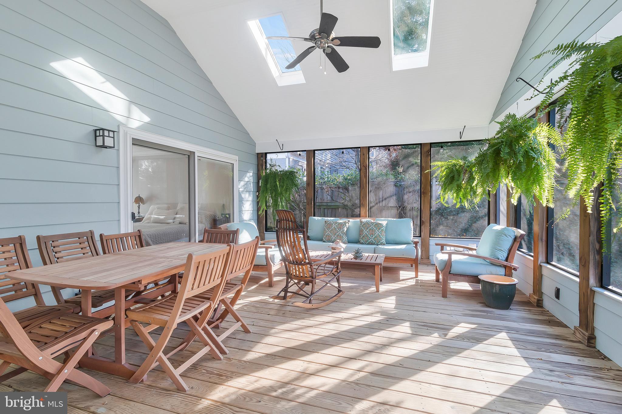 2812 Greenvale Street Chevy Chase, MD 20815 - Photo 13 of 27 a view of a patio with table and chairs potted plants with wooden floor and floor to ceiling window