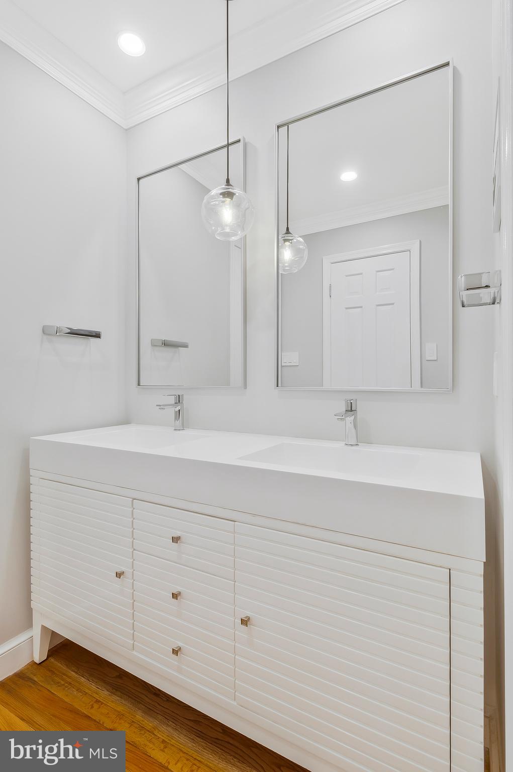 2812 Greenvale Street Chevy Chase, MD 20815 - Photo 19 of 27 a bathroom with a double vanity sink a mirror and a bathtub