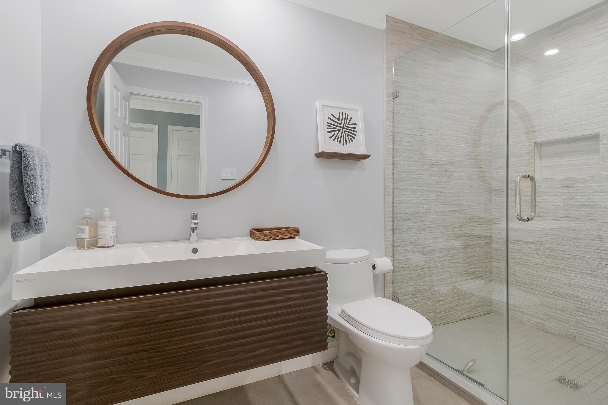2812 Greenvale Street Chevy Chase, MD 20815 - Photo 23 of 27 a bathroom with a sink a toilet and a mirror