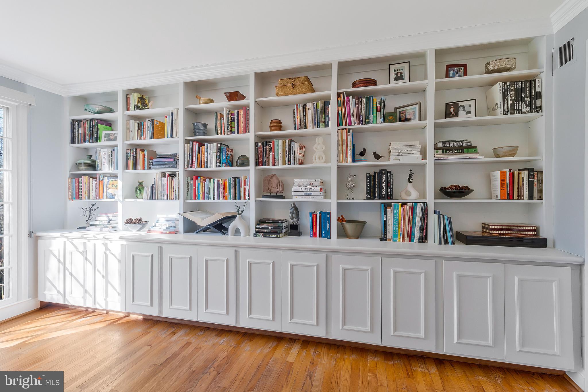 2812 Greenvale Street Chevy Chase, MD 20815 - Photo 9 of 27 a living room with hard wood floors and a book shelf