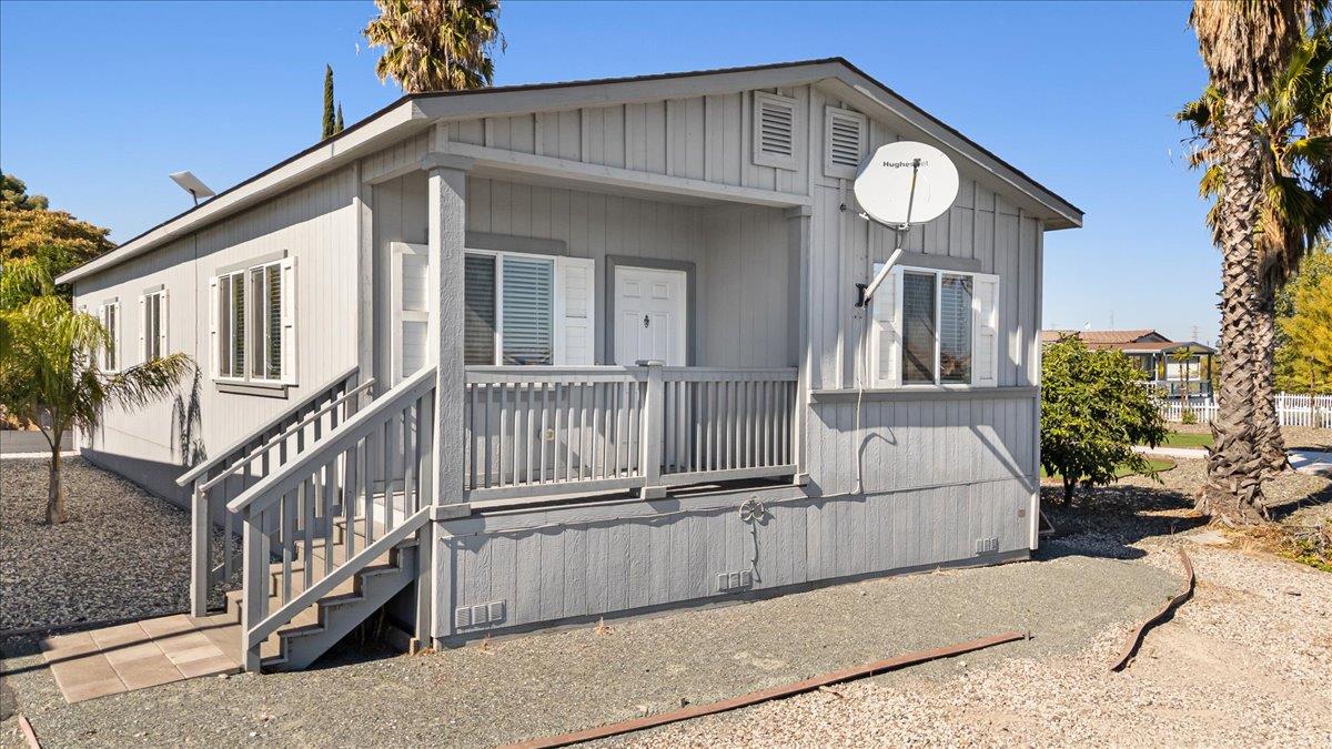 4399 Aplicella Court, Unit 75 Manteca, CA 95337 - Photo 1 of 30 a view of a house with wooden stairs
