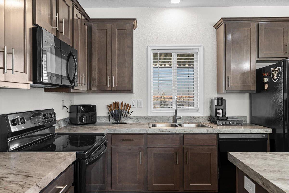 4399 Aplicella Court, Unit 75 Manteca, CA 95337 - Photo 15 of 30 a kitchen with stainless steel appliances granite countertop a sink stove and cabinets