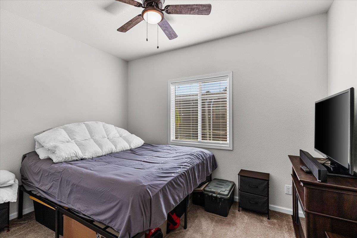 4399 Aplicella Court, Unit 75 Manteca, CA 95337 - Photo 20 of 30 a bedroom with a bed and a flat tv screen on a dresser
