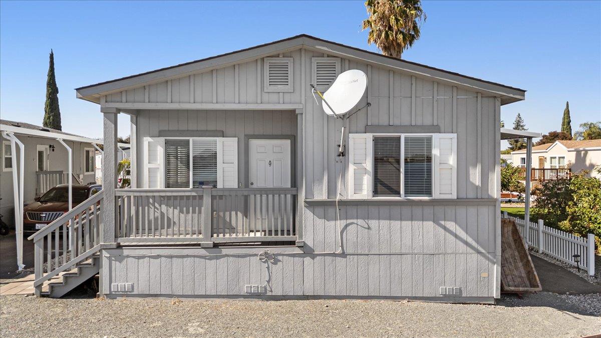 4399 Aplicella Court, Unit 75 Manteca, CA 95337 - Photo 2 of 30 a view of a house with a small yard and wooden floor
