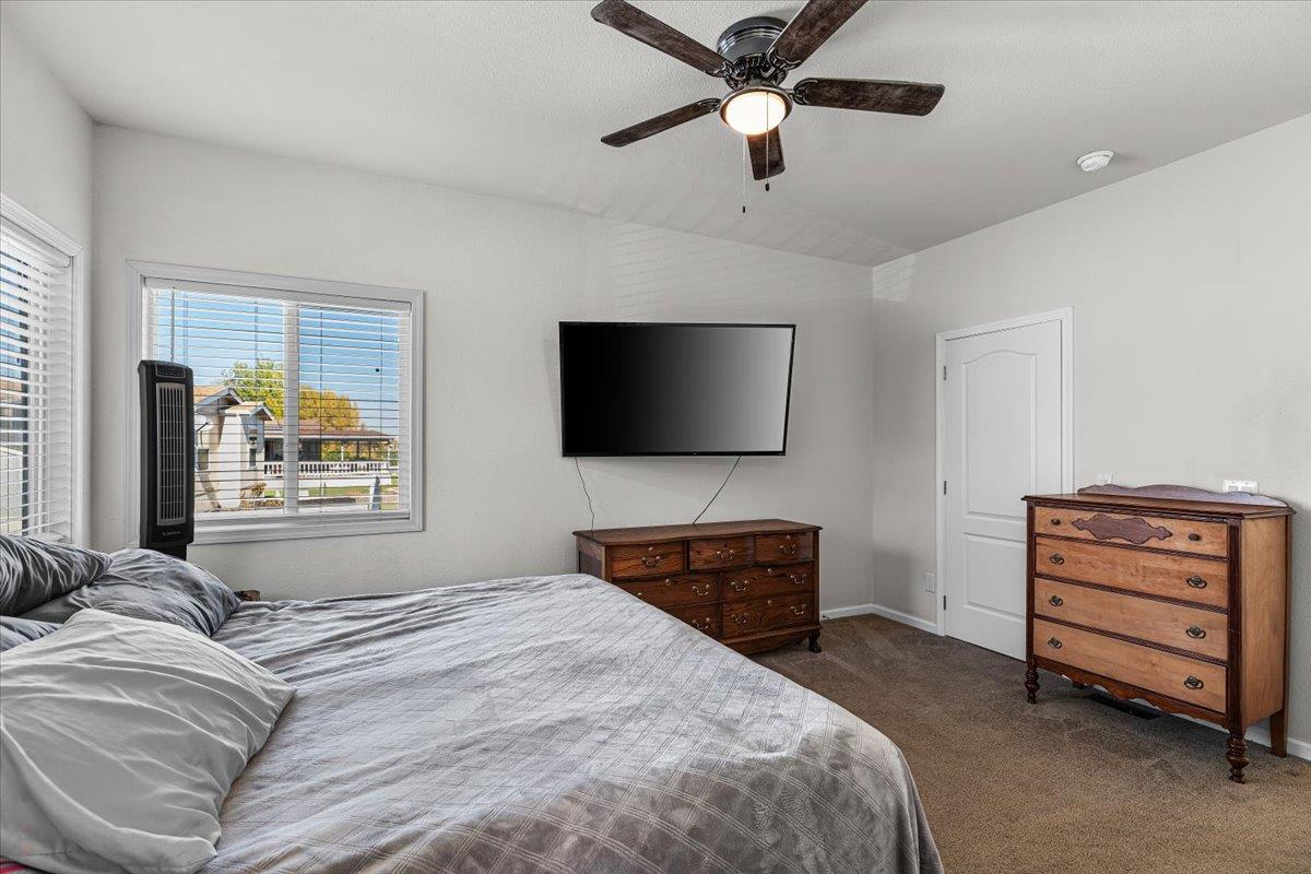 4399 Aplicella Court, Unit 75 Manteca, CA 95337 - Photo 24 of 30 a bedroom with a bed and a flat screen tv