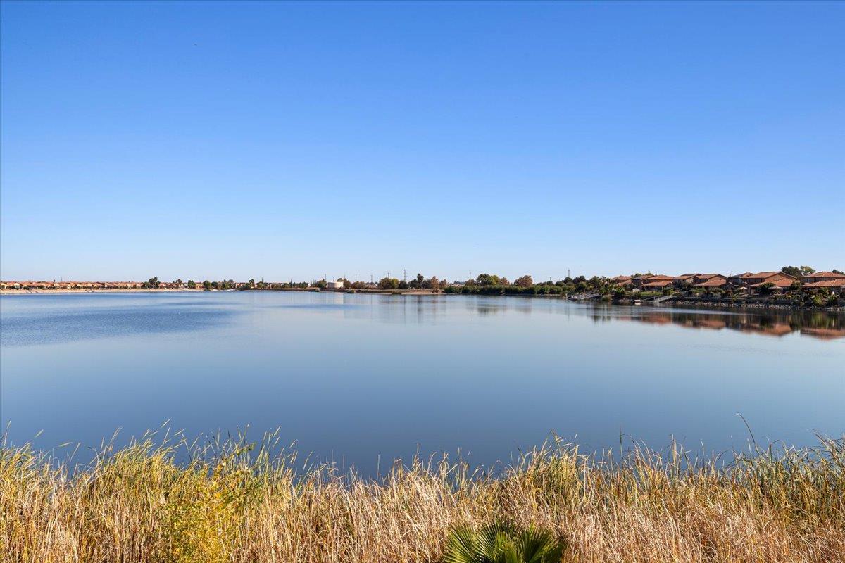 4399 Aplicella Court, Unit 75 Manteca, CA 95337 - Photo 30 of 30 a view of a lake with a building in the background