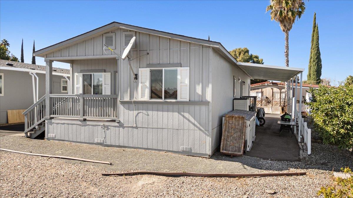 4399 Aplicella Court, Unit 75 Manteca, CA 95337 - Photo 3 of 30 a view of a house with a small yard and wooden fence