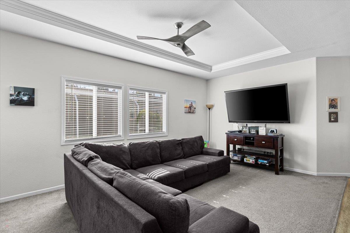 4399 Aplicella Court, Unit 75 Manteca, CA 95337 - Photo 10 of 30 a living room with furniture and a flat screen tv
