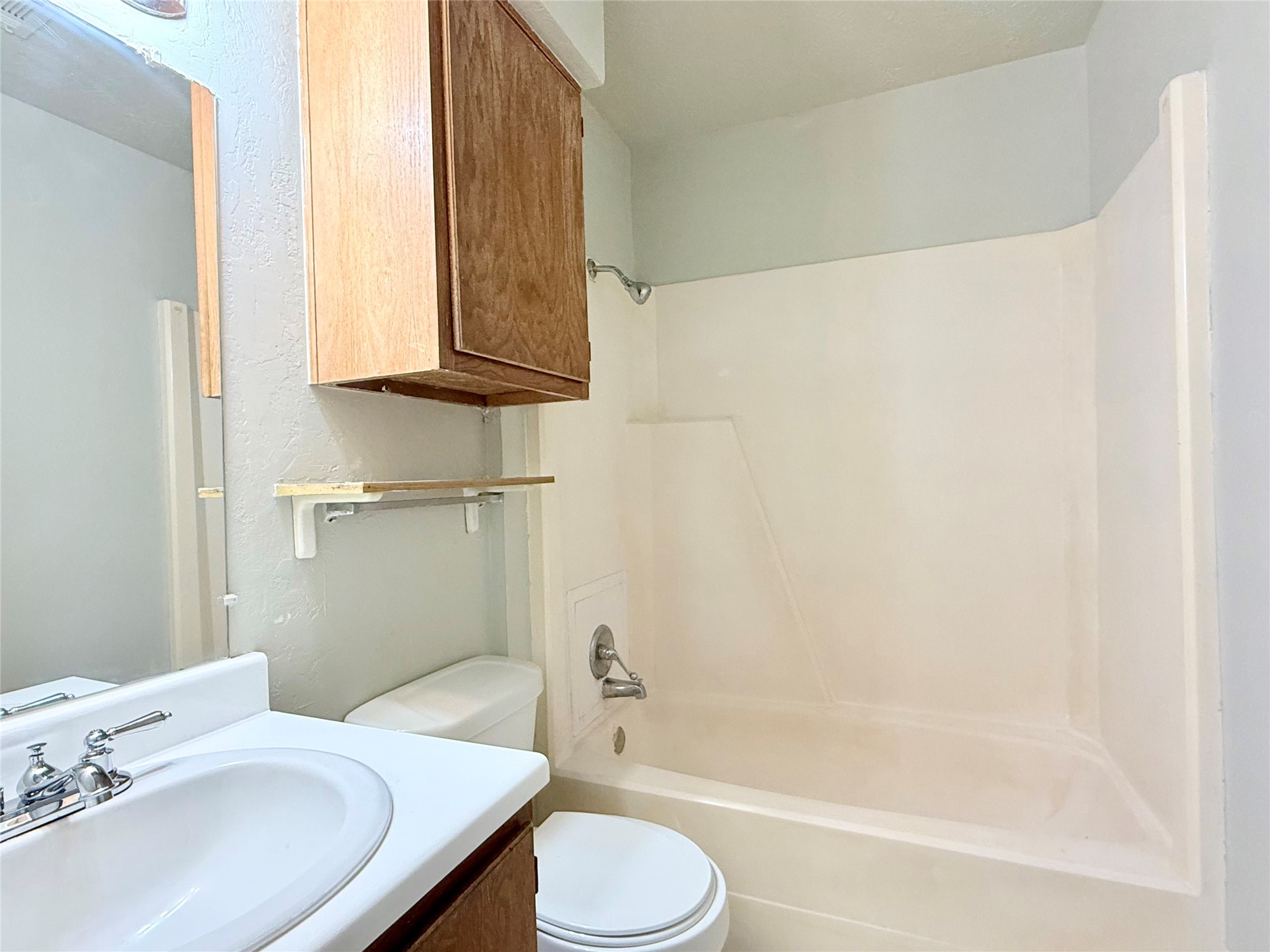 705 Ruth Court, Unit B Navasota, TX 77868 - Photo 12 of 14 a bathroom with a sink toilet and shower