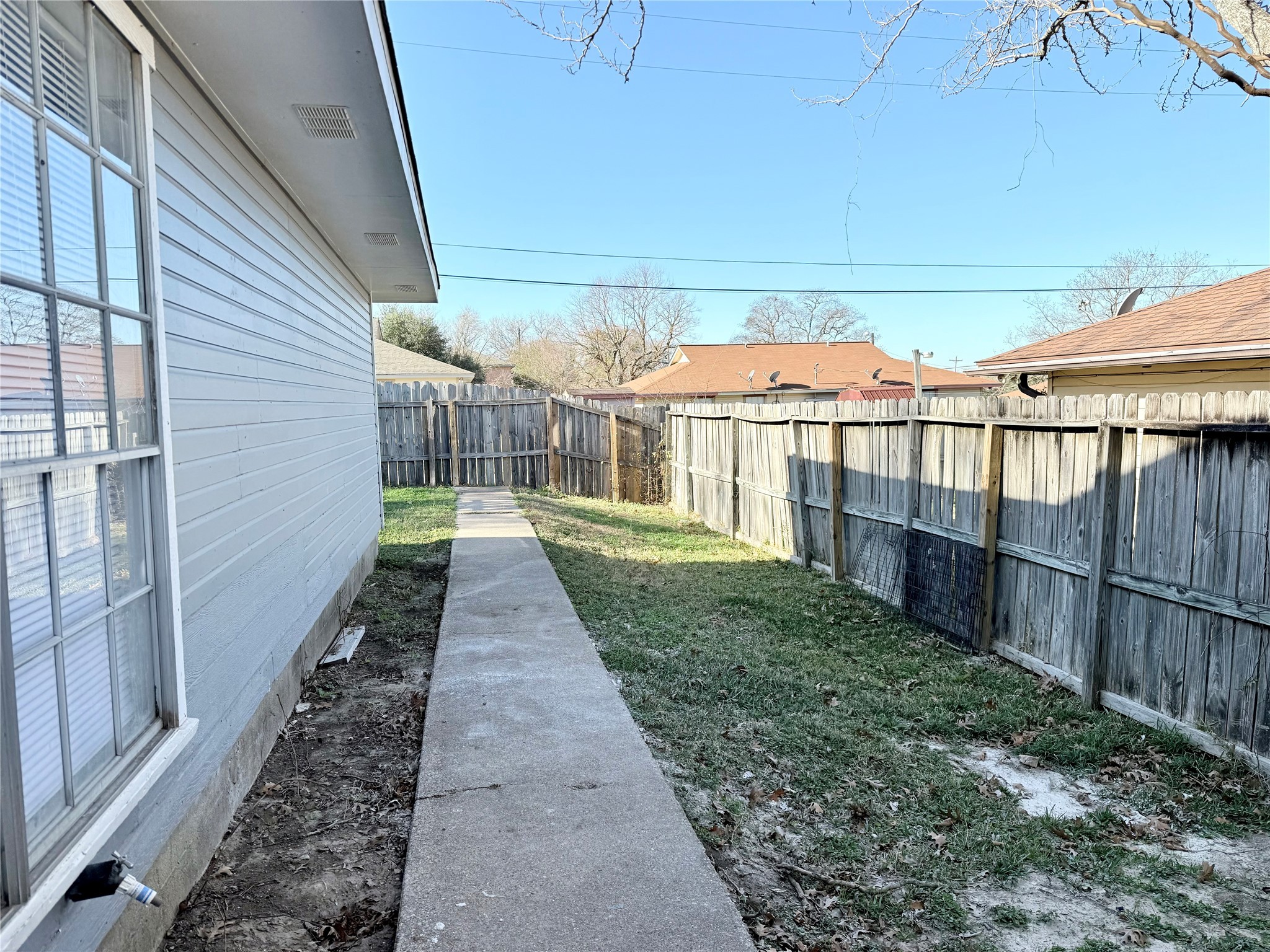 705 Ruth Court, Unit B Navasota, TX 77868 - Photo 13 of 14 a view of a pathway with a backyard