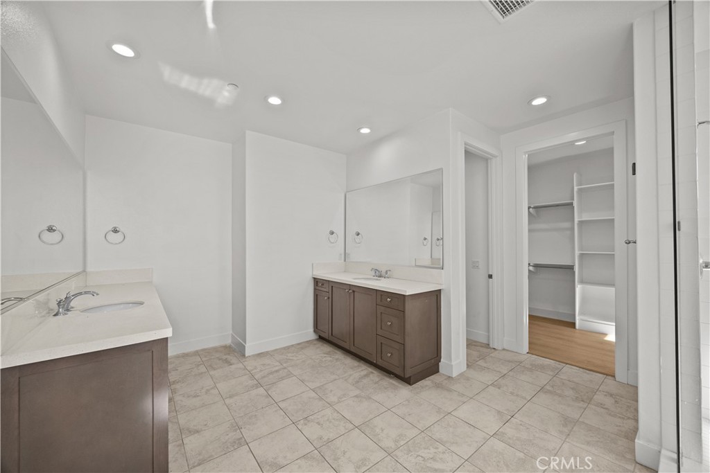 20638 Deer Grass Court Porter Ranch, CA 91326 - Photo 29 of 50 a bathroom with a sink vanity and tub